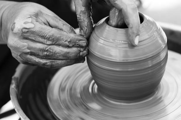 istock Potter making ceramic pot on the pottery wheel 831423316
