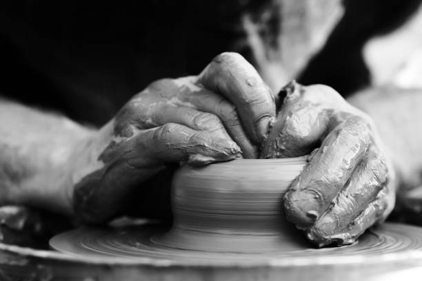 istock Potter making ceramic pot on the pottery wheel 831423324