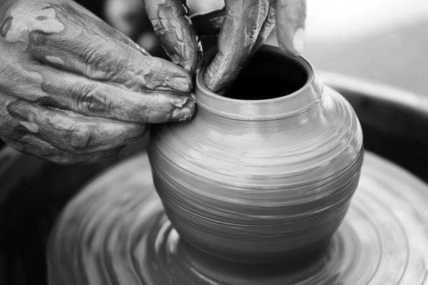 istock Potter making ceramic pot on the pottery wheel 831423330