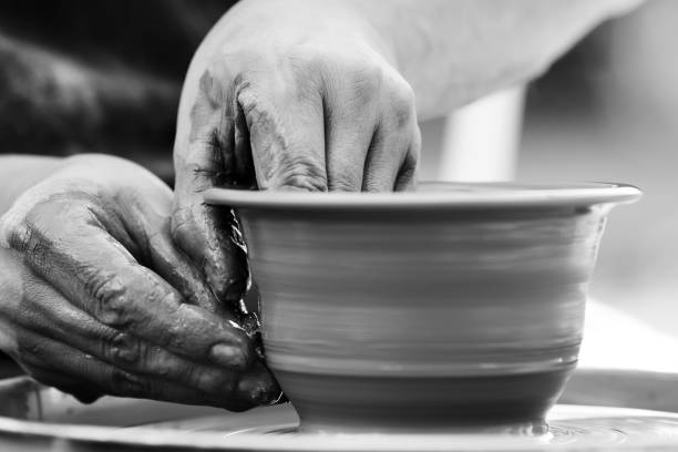 istock Potter making ceramic pot on the pottery wheel 831423346