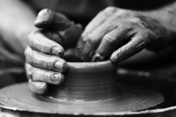 istock Potter making ceramic pot on the pottery wheel 831423374