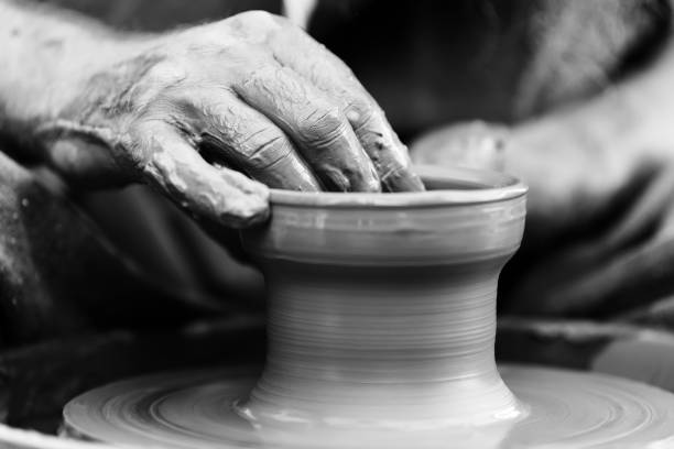istock Potter making ceramic pot on the pottery wheel 831423392