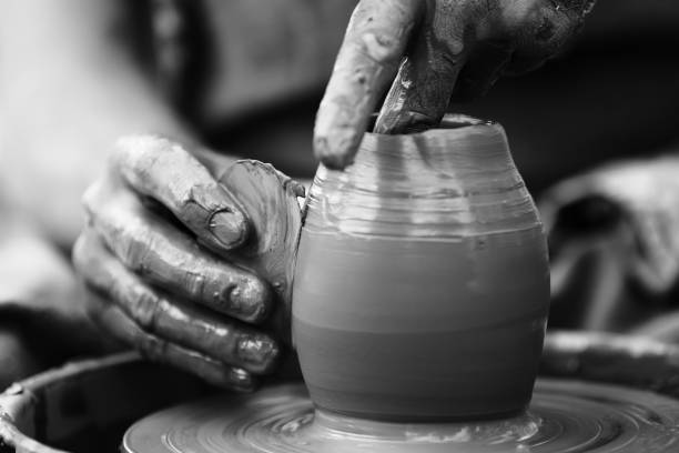 istock Potter making ceramic pot on the pottery wheel 831423400