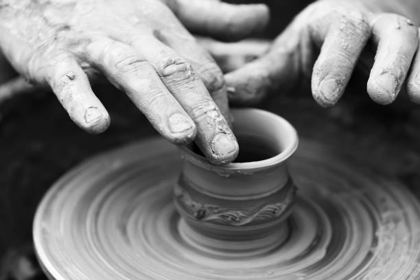 istock Potter making ceramic pot on the pottery wheel 831423416