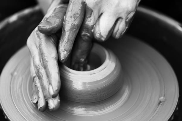 istock Potter making ceramic pot on the pottery wheel 831423420