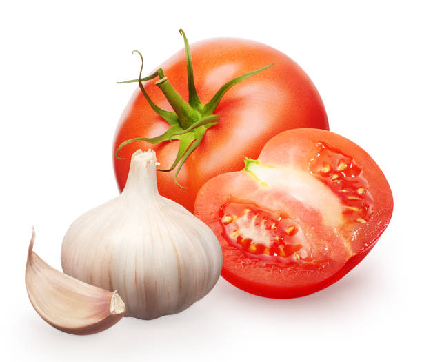 istock Red tomato with green leaf, half and garlic with clove 831423486