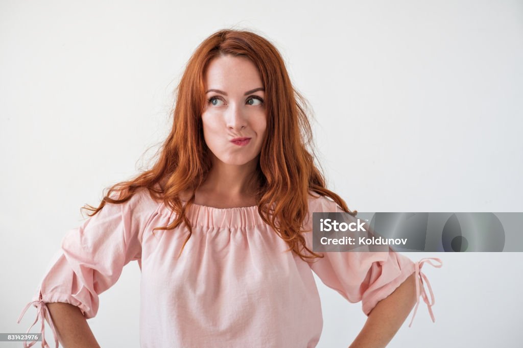 Caucasian woman model with ginger hair posing indoors Portrait of young tender redhead woman with healthy freckled skin thinging about problems. Try to find right desicion Women Stock Photo