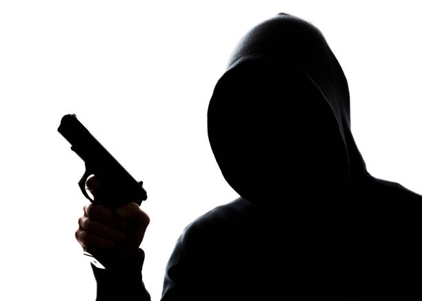 istock Man in hoodie with handgun 831426874