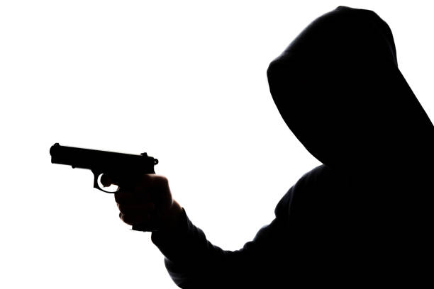 istock Man in hoodie with handgun 831426896