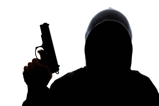 istock Man in hoodie with handgun 831426918