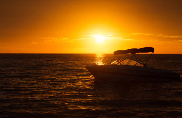 istock Silhouette of a motorboat during the sunset 831432480