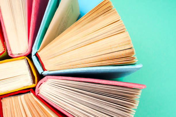 istock Top view of bright colorful hardback books in a circle. 831432954