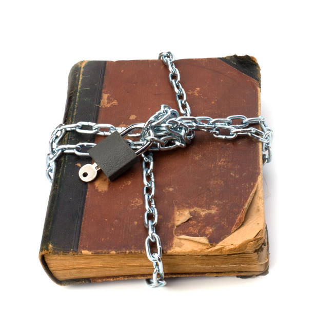 istock tattered book with chain and padlock isolated on white background 831433548