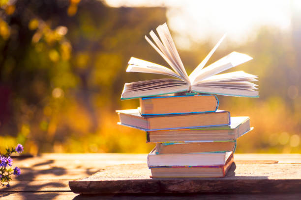 open book on wooden table on natural background. soft focus - brown paper imagens e fotografias de stock