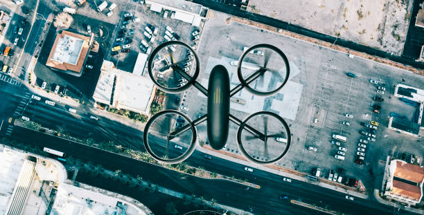 Drone on the lookout. It flys above the streets of a city looking down on buildings and streets.