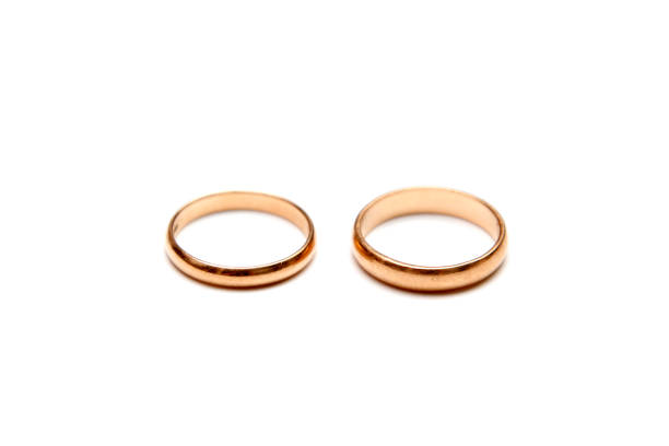 istock Gold wedding rings on white background 831446306