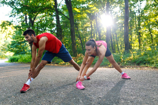 istock Young couple stretching his muscles outdoors before running. 831446446