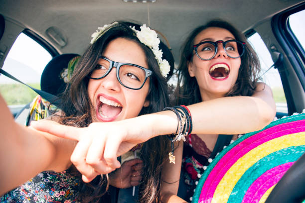 istock Friends travelling in a car and pointing through the window 831447038