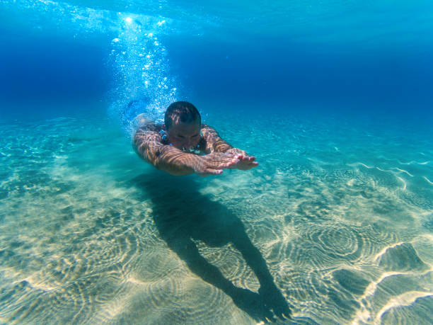 istock Man swimming underwater in the sea. 831449736