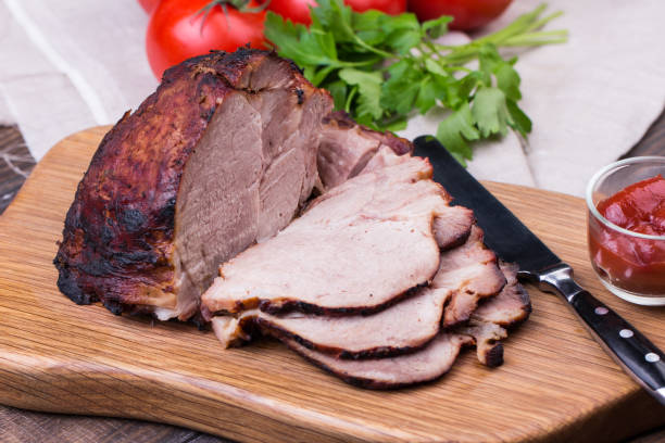 istock Roast pork with herbs and vegetables. 831450180
