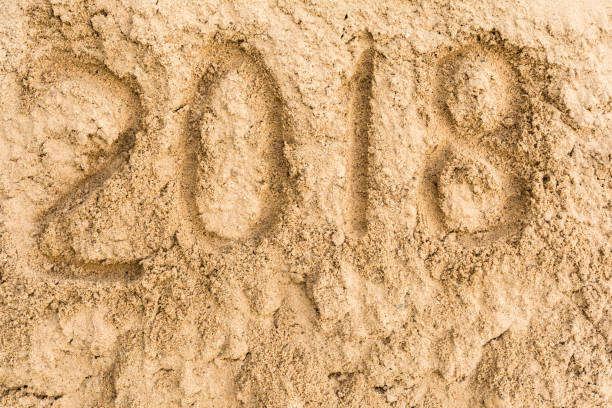 istock Inscription 2018 on the yellow sand 831452626