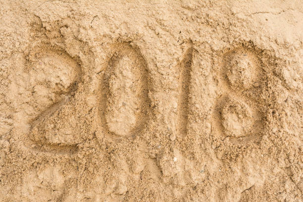 istock Inscription 2018 on the yellow sand 831452632