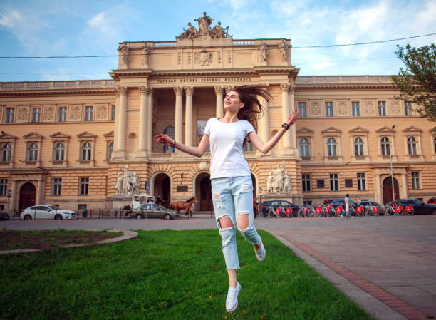 istock Happy jumping student girl in park on background university 831468868