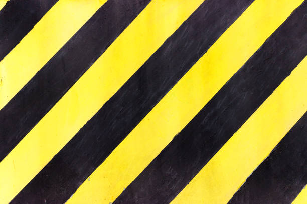 istock Safety stripes on construction site, Black and yellow Under construction sign over a grunge texture, top view 831472306