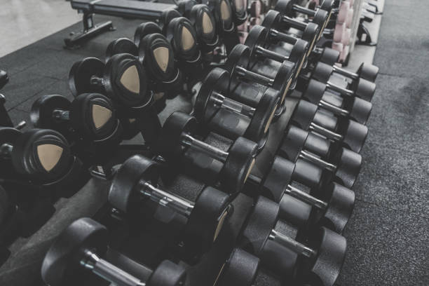 istock Black hard iron dumbbells locating in row 831474676