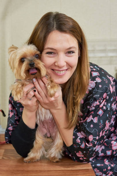 istock Smiling woman and yorkshire terrier. 831474972
