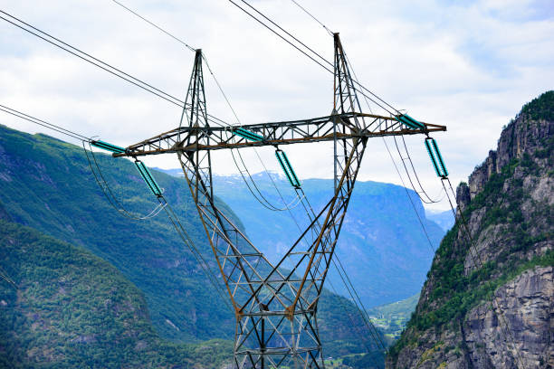 Pylon in mountains, power cables and glaicer in background