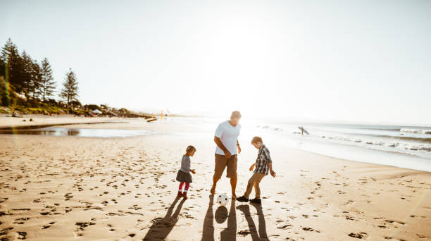 happy family playing soccer on the beach happy family playing soccer on the beach 9 stock pictures, royalty-free photos & images