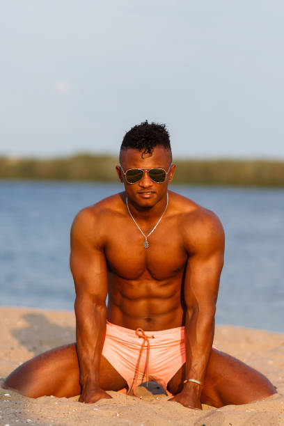 筋肉運動セクシーな若者の下着姿で裸の胴体とビーチで。ホットのブラックの美しい人、手足が長いスポーツ ボディとフィットネス モデル。 - men black body building african descent ストックフォトと画像