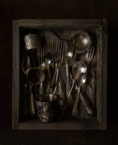 istock Rough wooden box full of antique silverware 831487012