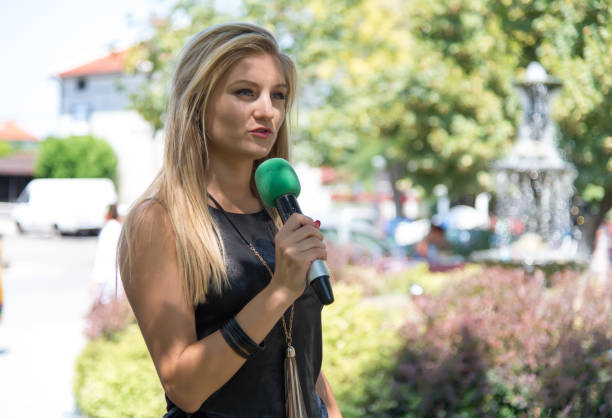 istock Happy female news reporter at work. 831487484