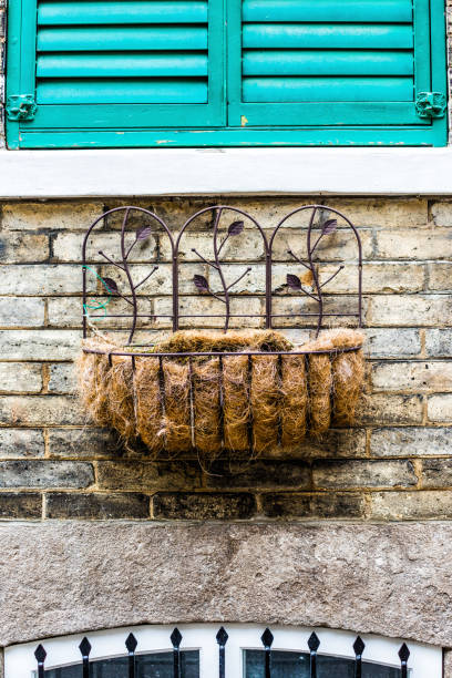 istock Hanging empty flower crate on wall by window in Quebec City, Canada 831488044
