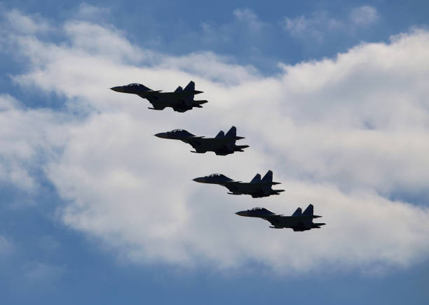 istock Fighters  flying in a cloudy sky 831498750