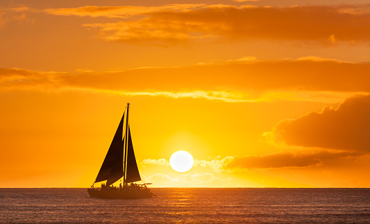Sail boat sailing against a beautiful sunset