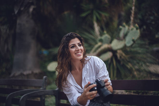 istock Photographer woman in park 831499554