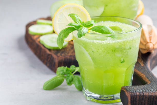 istock Healthy lemonade with cucumber, basil, lemon, honey and sparkling water, horizontal, copy space 831508982