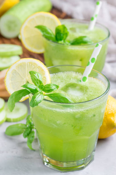 istock Healthy lemonade with cucumber, basil, lemon, honey and sparkling water, vertical 831509006