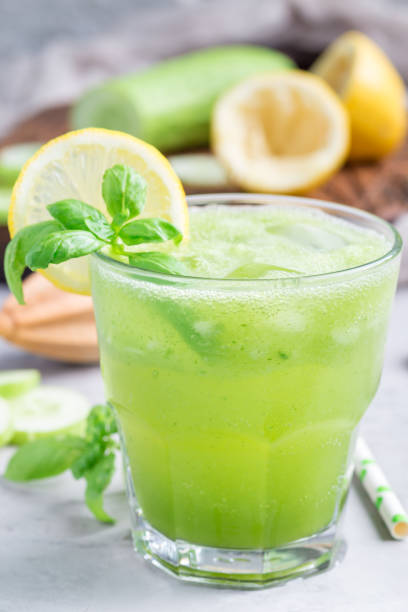 istock Healthy lemonade with cucumber, basil, lemon, honey and sparkling water, vertical 831509010