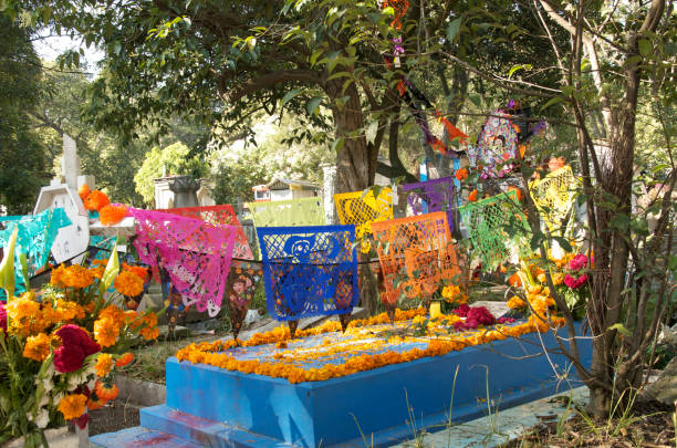 istock Flags and flowers adorn the grave for Halloween 831512130