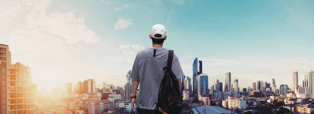 istock Panoramic a man with backpack standing at sightseeing city view in sunrise 831515026