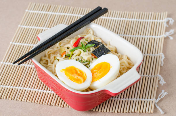 istock Instant noodles with boiled egg and seaweed in a bowl 831517848