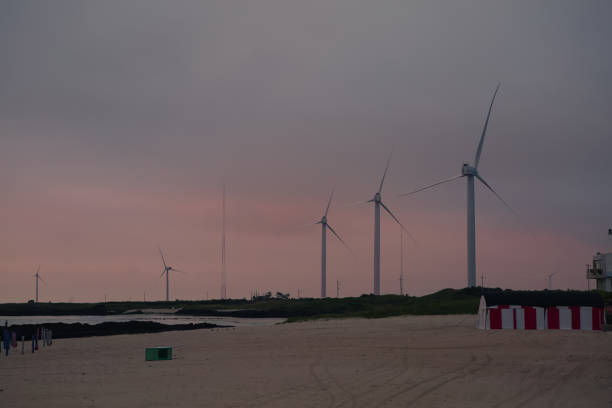 turbina generatore eolico in mare al tramonto - climate invention energy tide foto e immagini stock