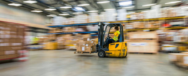istock Panning Shot Of Moving Forklift In A Warehouse 831536600