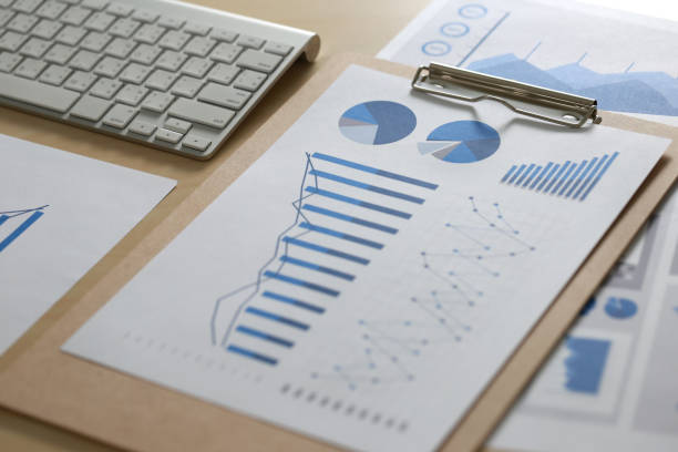 istock Business reports  Teamwork on table report  of documents Blue graphs and charts financial paperwork and reportsà¸ 831540284