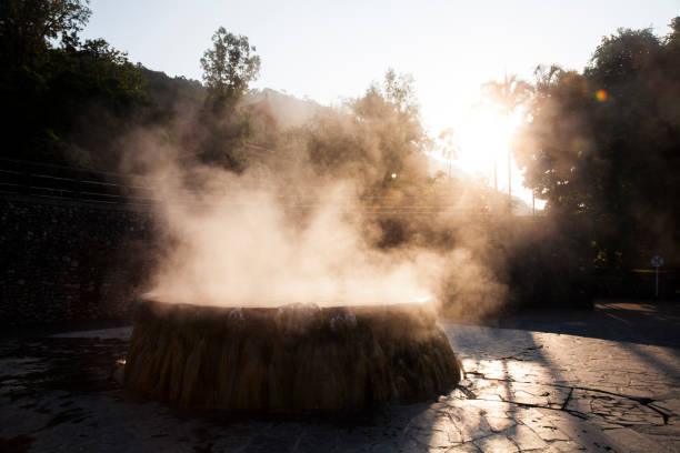 volcanic natural hot spring mineral water pool with steam spa and sun reflect light travel landmark background lampang thailand landscape colorful dark tone, Ruksavarin Hot Spring \