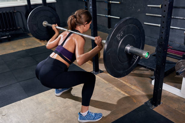 istock Back View of Woman in Shoulder Squat 831540544